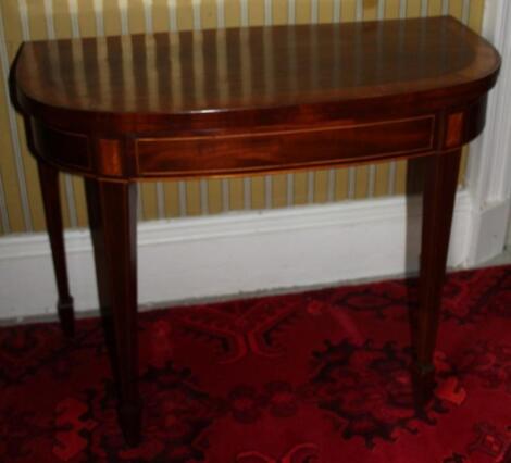 A George III mahogany and satinwood demi-lune card table