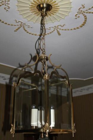 A brass lantern shaped light fitting