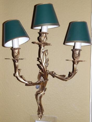 A set of three brass wall lights