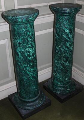 A pair of green simulated marble columns