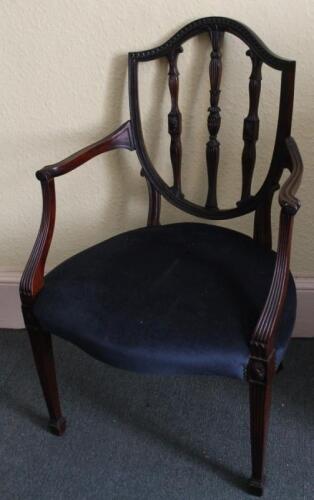 A mahogany open arm chair in Sheraton style