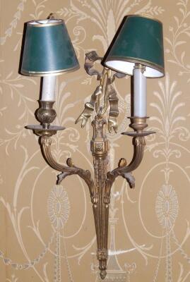 A pair of gilt metal two branch wall lights in Adam style