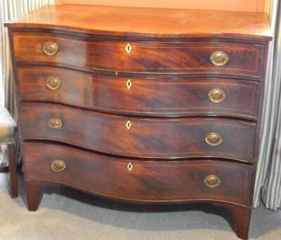 An early 19thC mahogany serpentine fronted chest of drawers