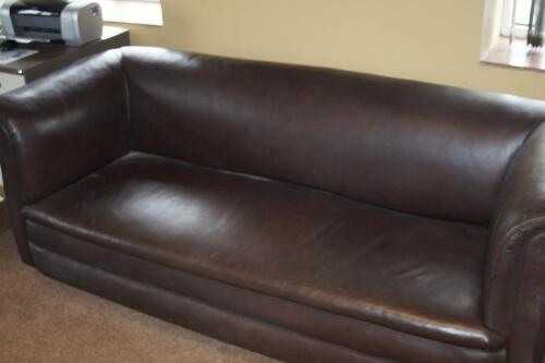 A brown leather chesterfield sofa