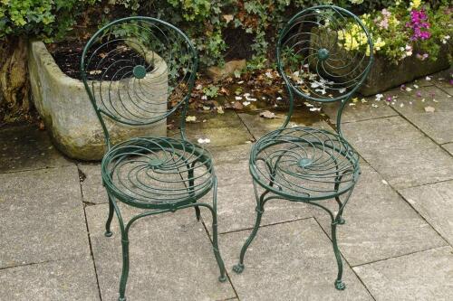 Four wrought iron and wirework garden chairs