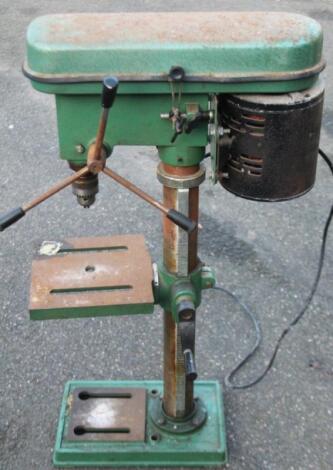 A metal cased electric freestanding pillar drill