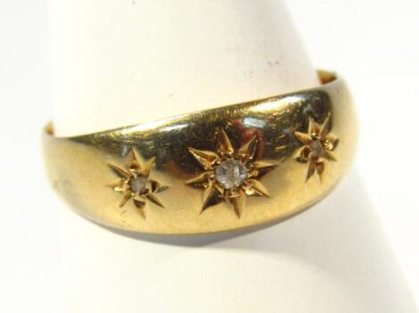 A 18ct gold ring set with three small diamonds