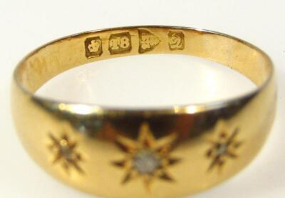 A 18ct gold ring set with three small diamonds - 2