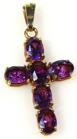 A 9ct gold crucifix set with amethyst coloured stones