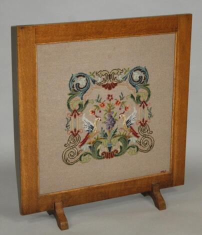 An early 20thC oak framed fire screen