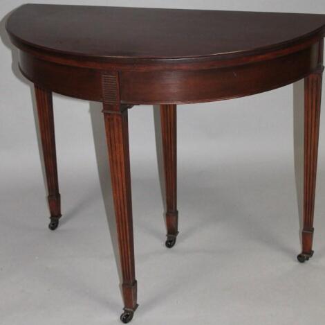 An Edwardian style mahogany fold over games table