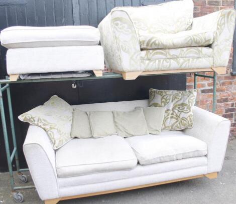 A modern three piece matched lounge suite