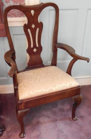 A walnut open arm chair