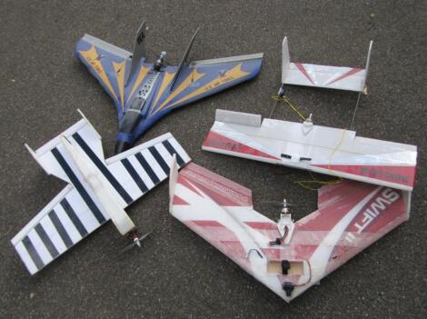 Four various polystyrene remote controlled planes.