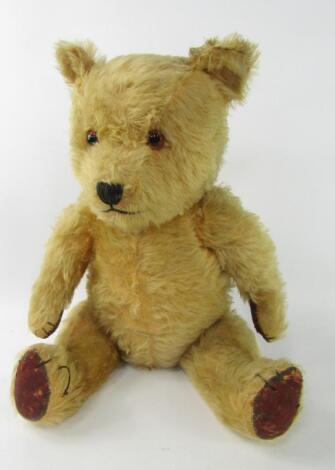 A golden mohair straw filled teddy bear