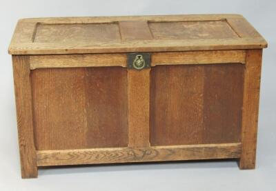 An oak panelled chest with brass lock plate