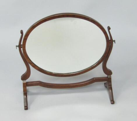 An Edwardian oval mahogany swing framed toilet mirror