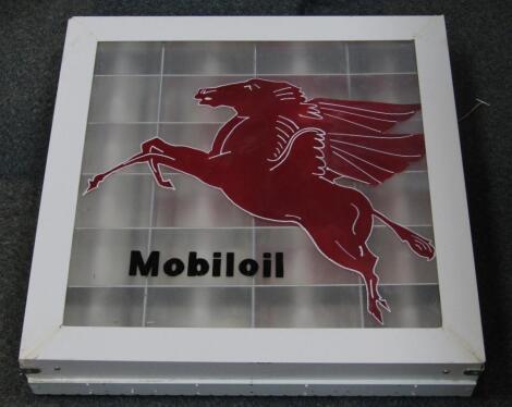 A Mobil oil glass and white wooden framed illuminated sign