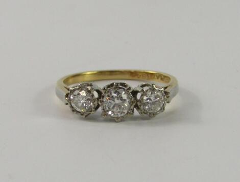 An 18ct gold platinum and diamond three stone ring