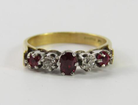 An 18ct gold ruby and diamond five stone ring