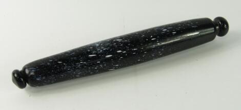 A Victorian black and speckled white glass rolling pin