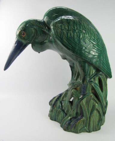 A green and blue glazed pottery figure of a heron