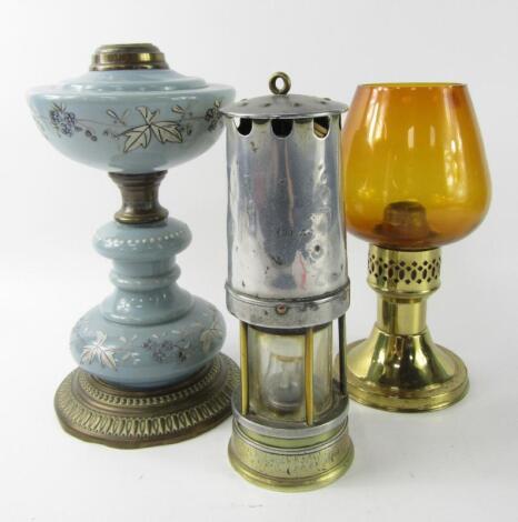 A brass and turquoise opaline glass oil lamp