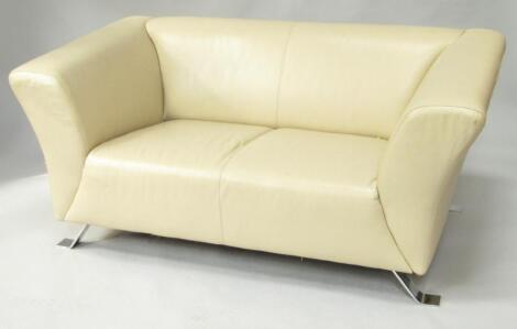 A cream leather two seater sofa