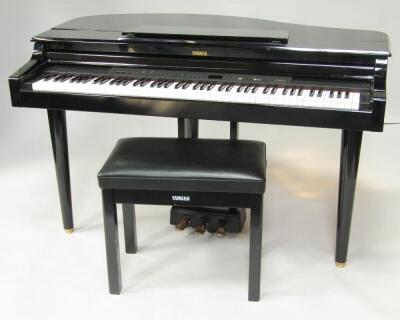 A Yamaha black cased Clavinova CLP-555 electric piano