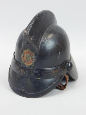 A 20thC leather fireman's helmet