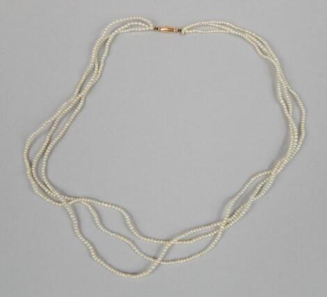 A dainty three strand seed pearl necklace