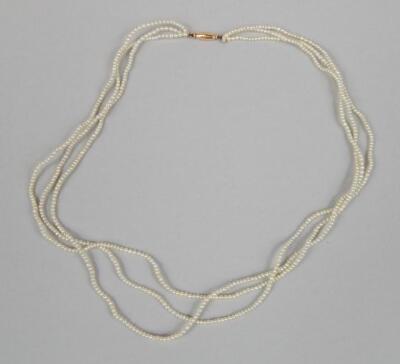 A dainty three strand seed pearl necklace