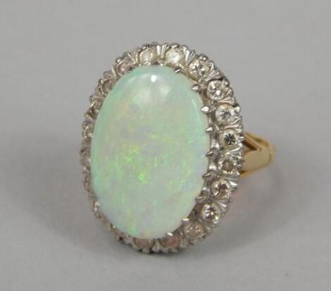 A large opal and diamond set dress ring