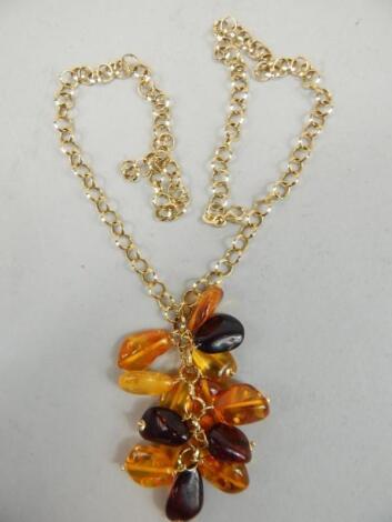 An amber coloured bead and yellow metal necklace