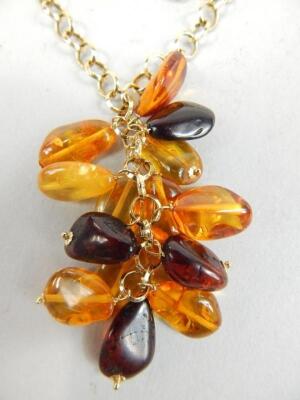 An amber coloured bead and yellow metal necklace - 2