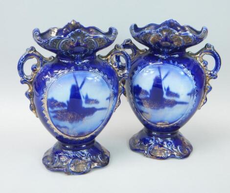 A pair of early 20thC Staffordshire pottery vases