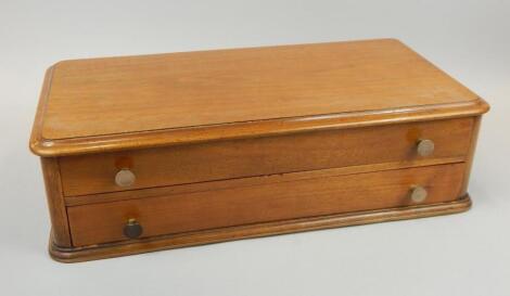 A mahogany two drawer collector's cabinet