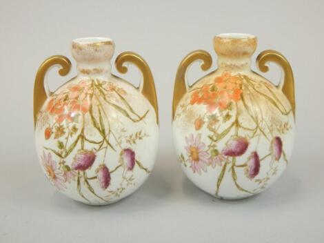 A pair of Staffordshire globular two handled vases