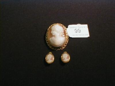 A shell cameo brooch in yellow metal frame and similar ear clips