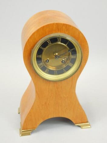 A mantel clock in mahogany case