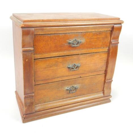 A late 19th-early 20thC stained pine miniature chest of drawers