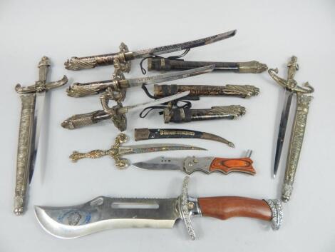 A collection of small elaborately carved fantasy style daggers