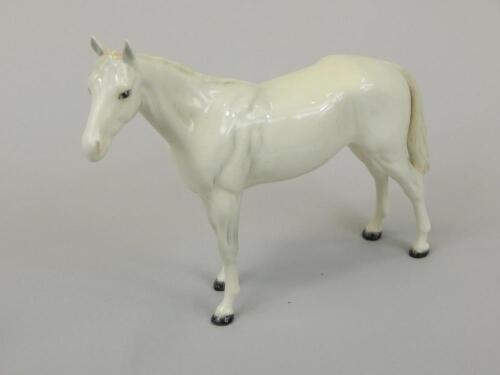 A Beswick figure of a standing horse in white