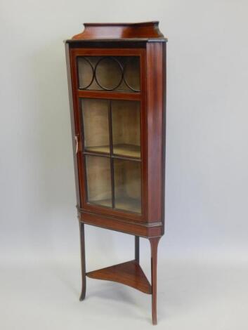 An Edwardian mahogany and box wood sprung corner cabinet