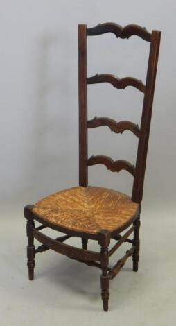 An Arts and Crafts style stained beech ladderback chair