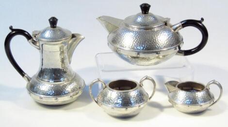 A 20thC Arts and Crafts pewter four piece tea service