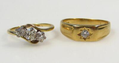 A yellow metal platinum and diamond three stone ring