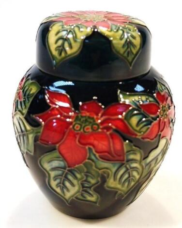 A Moorcroft Poinsettia pattern jar and cover