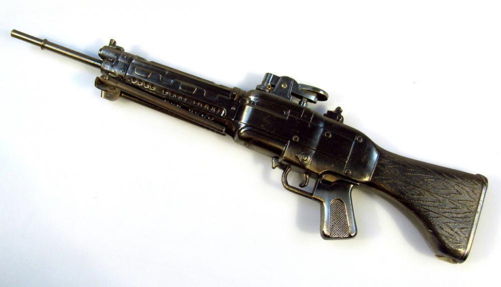 machine gun cigarette lighter A novelty cigarette lighter formed as a machine gun