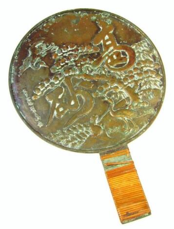 A Japanese later Meiji period bronze hand mirror